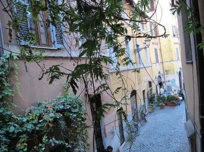 an alley with a building and a tree next to it at La Maison de Kappa in Rome