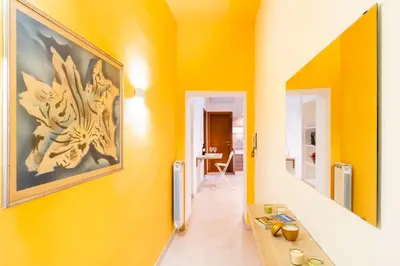 a hallway with yellow walls and a picture on the wall at Apartment Maria in Monti in Rome