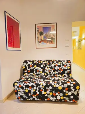a couch sitting in a living room with a blanket at Apartment Maria in Monti in Rome