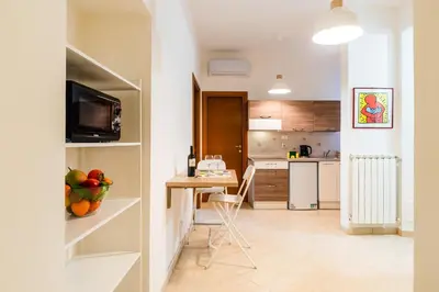 a small kitchen with a table and a counter top at Apartment Maria in Monti in Rome