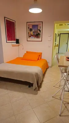 a bedroom with a bed and a table and chairs at Apartment Maria in Monti in Rome