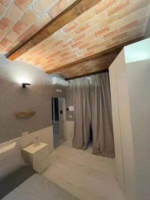 a room with a brick ceiling and a room with curtains at Villafranca17 in Rome