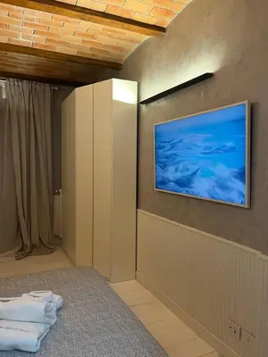 a room with a television on a wall with towels at Villafranca17 in Rome