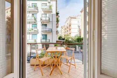 a balcony with a table and chairs and a building at Cozy 2-Bedroom Flat with Balcony in Monteverde in Rome