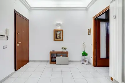 an empty hallway with a door and a tiled floor at Cozy 2-Bedroom Flat with Balcony in Monteverde in Rome