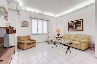 a living room with a couch and a table at Cozy 2-Bedroom Flat with Balcony in Monteverde in Rome