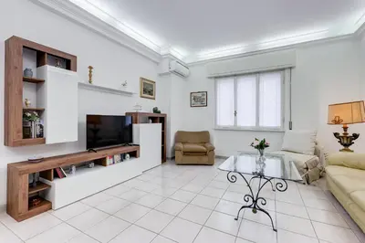 a living room with a couch and a tv at Cozy 2-Bedroom Flat with Balcony in Monteverde in Rome