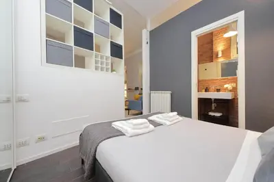 a bedroom with a white bed and a window at Il Rifugio di Boezio by DomusDimore in Rome