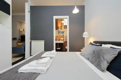 a bedroom with a white bed with two towels on it at Il Rifugio di Boezio by DomusDimore in Rome