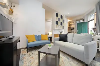 a living room with a white couch and yellow pillows at Il Rifugio di Boezio by DomusDimore in Rome