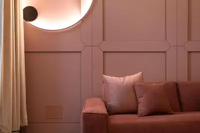 a living room with a couch and a round mirror at Colonna Collection in Rome