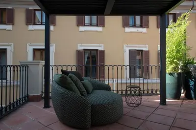 a chair sitting on a patio in front of a building at Colonna Collection in Rome