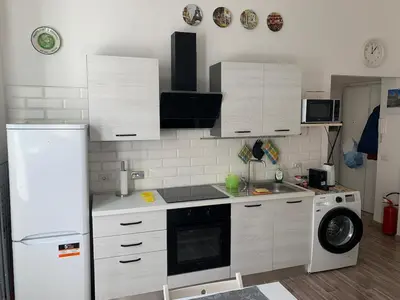 a kitchen with a refrigerator and a washing machine at Apartment in Testaccio in Rome