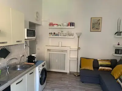 a kitchen and living room with a couch and a sink at Apartment in Testaccio in Rome
