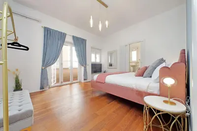 a large bedroom with a bed and a couch at New Apartment with balcony - 150m Metro A in Rome
