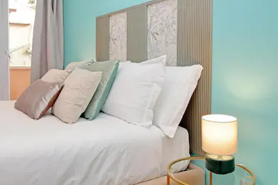 a bedroom with a bed with white pillows at New Apartment with balcony - 150m Metro A in Rome