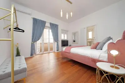 a large bedroom with a bed and a table at New Apartment with balcony - 150m Metro A in Rome