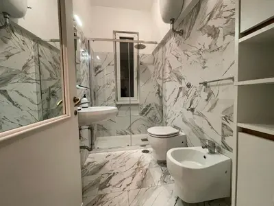 a bathroom with a toilet and a sink and a shower at Mazzoni Suite, Panoramic Terrace and Comfort in Rome