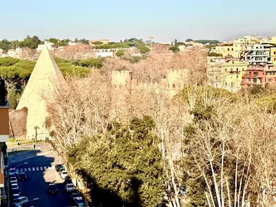 a view of a city with trees and buildings at Piramide Cestia Apartment in Rome
