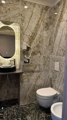 a bathroom with a toilet and a sink and a mirror at Bed and Breakfast Eritrea in Rome
