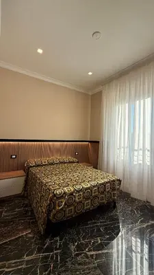 a bedroom with a bed and a large window at Bed and Breakfast Eritrea in Rome