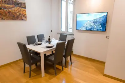 a dining room with a table and chairs at Amor Guest House San Giovanni in Rome