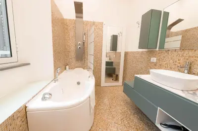 a bathroom with a tub and a sink at Amor Guest House San Giovanni in Rome