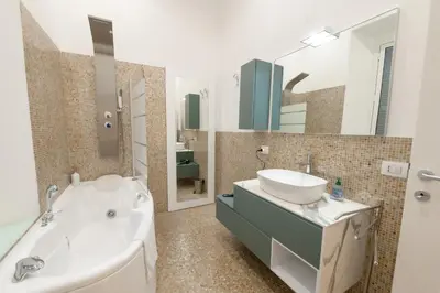 a bathroom with a tub and a sink and a bath tub at Amor Guest House San Giovanni in Rome