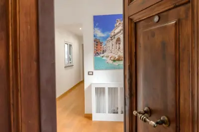 an open door with a painting on the wall at Amor Guest House San Giovanni in Rome