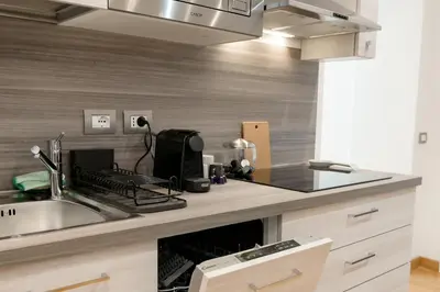 a kitchen with a sink and a counter top at Amor Guest House San Giovanni in Rome