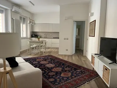 a white kitchen with a table and chairs in it at Casa Giovi in Rome