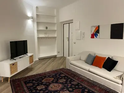 a living room with a couch and a tv at Casa Giovi in Rome