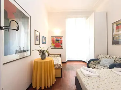 a living room with a yellow table and a couch at Silenzioso, grande, comodo alloggio a Trastevere in Rome