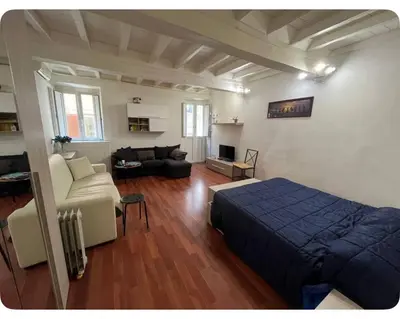 a bedroom with a bed and a living room at Casa in centro storico Largo Argentina in Rome