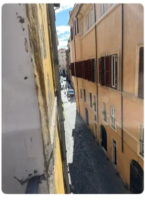 a view of an alley between two buildings at Casa in centro storico Largo Argentina in Rome