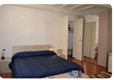 a bedroom with a bed with a blue blanket on it at Casa in centro storico Largo Argentina in Rome