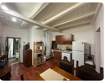 a kitchen with a white refrigerator and a stove at Casa in centro storico Largo Argentina in Rome