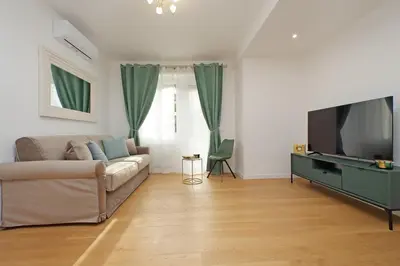 a living room with a couch and a flat screen tv at Graceful Apartment near St Peter METRO 100 mt in Rome
