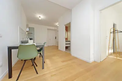 a dining room with a table and a green chair at Graceful Apartment near St Peter METRO 100 mt in Rome