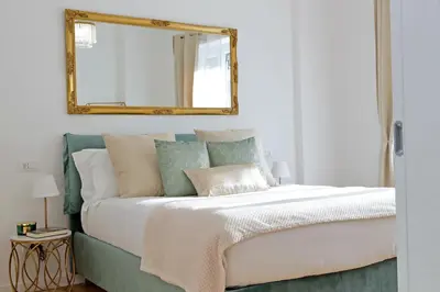 a bedroom with a large bed with a mirror on the wall at Graceful Apartment near St Peter METRO 100 mt in Rome
