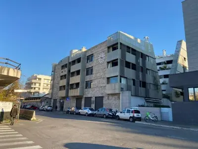 a building with cars parked on the side of a street at P&P Luxury Home in Rome
