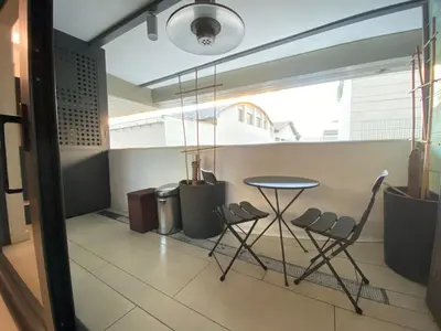 a table and chairs in a room with a window at P&P Luxury Home in Rome