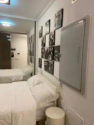 a hospital room with two beds and a mirror at P&P Luxury Home in Rome