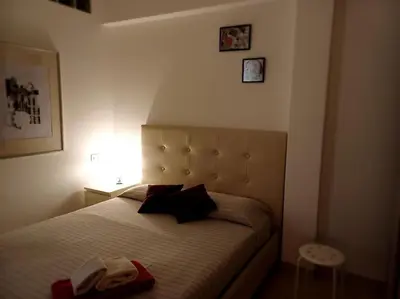 a bedroom with a bed with a red towel on it at Nido rinnovato in Rome