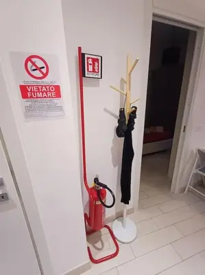a room with a fire extinguisher and a fire hydrant and a sign at Nido rinnovato in Rome