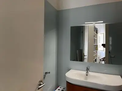a bathroom with a sink and a mirror at Nido rinnovato in Rome