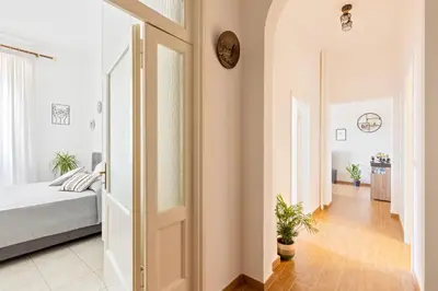 a bedroom with a bed and a clock on the wall at Cozy and Bright Pyramid Apartment in Rome
