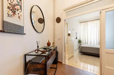 a room with a mirror and a table and a bed at Cozy and Bright Pyramid Apartment in Rome