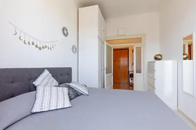 a bedroom with a bed with pillows on it at Cozy and Bright Pyramid Apartment in Rome