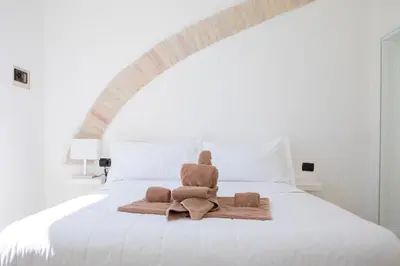 a pile of towels sitting on top of a bed at Casa Carmine in Trastevere in Rome